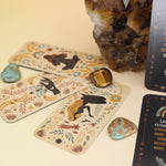 The Witch Magick Affirmation + Divination Cards against a citrine piece and all over on a pink and yellow background.