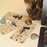 The Witch Magick Affirmation + Divination Cards against a citrine piece and all over on a pink and yellow background.