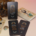 The Witch Magick Affirmation + Divination Cards against a citrine piece and all over on a pink and yellow background.
