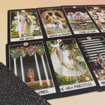 The contents of the Intuitive Night Goddess Tarot Deck on a pink and yellow background.