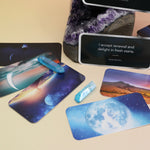 Some of the Moon Magick Affirmation + Divination Cards laying out on an amethyst piece and on a pink and yellow background.