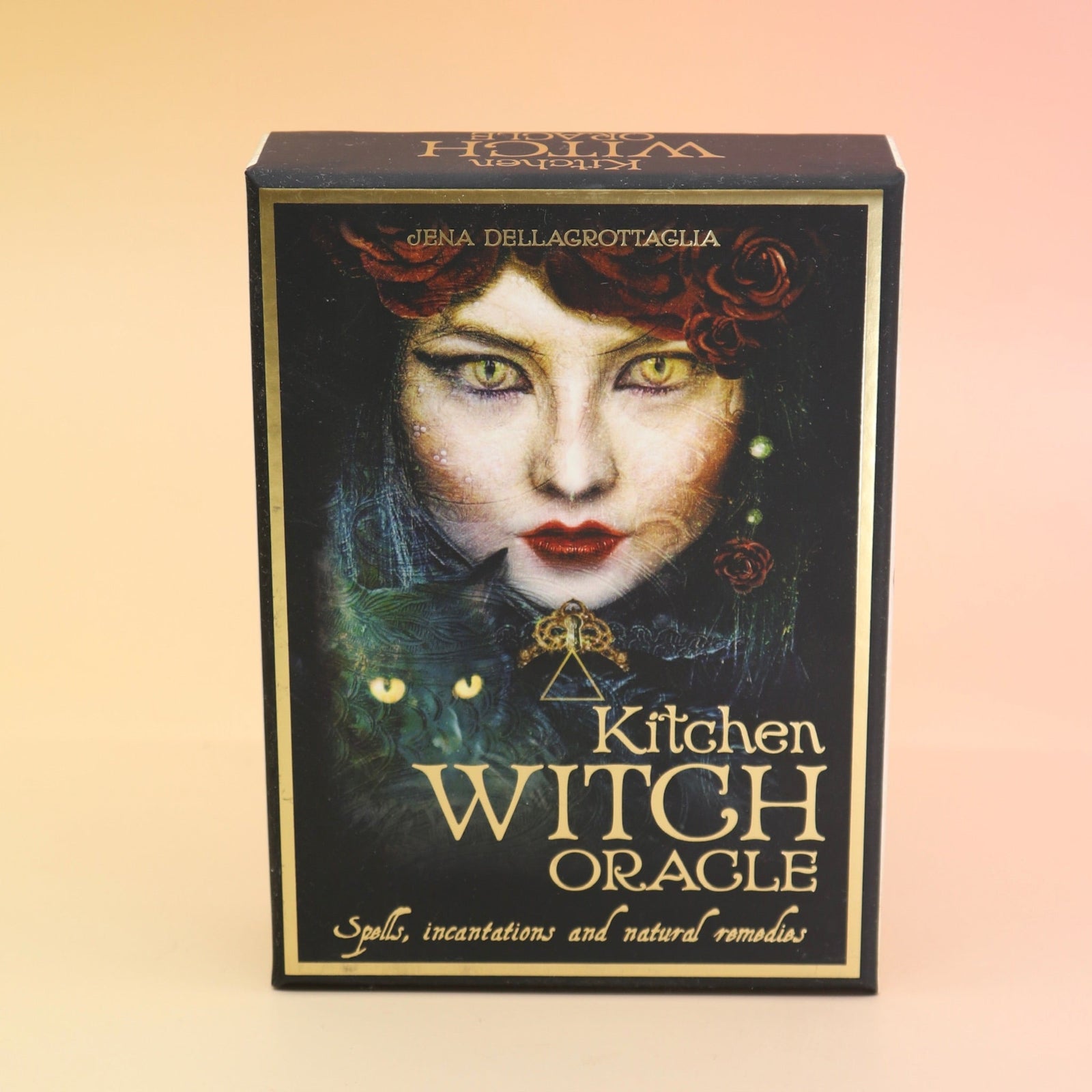 The Kitchen Witch Oracle Deck on a pink and yellow background.