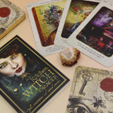 The contents of the Kitchen Witch Oracle Deck on a pink and yellow background.