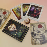 The contents of the Kitchen Witch Oracle Deck on a pink and yellow background.