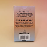The back of the Affirmation Card Deck on a pink and yellow background.