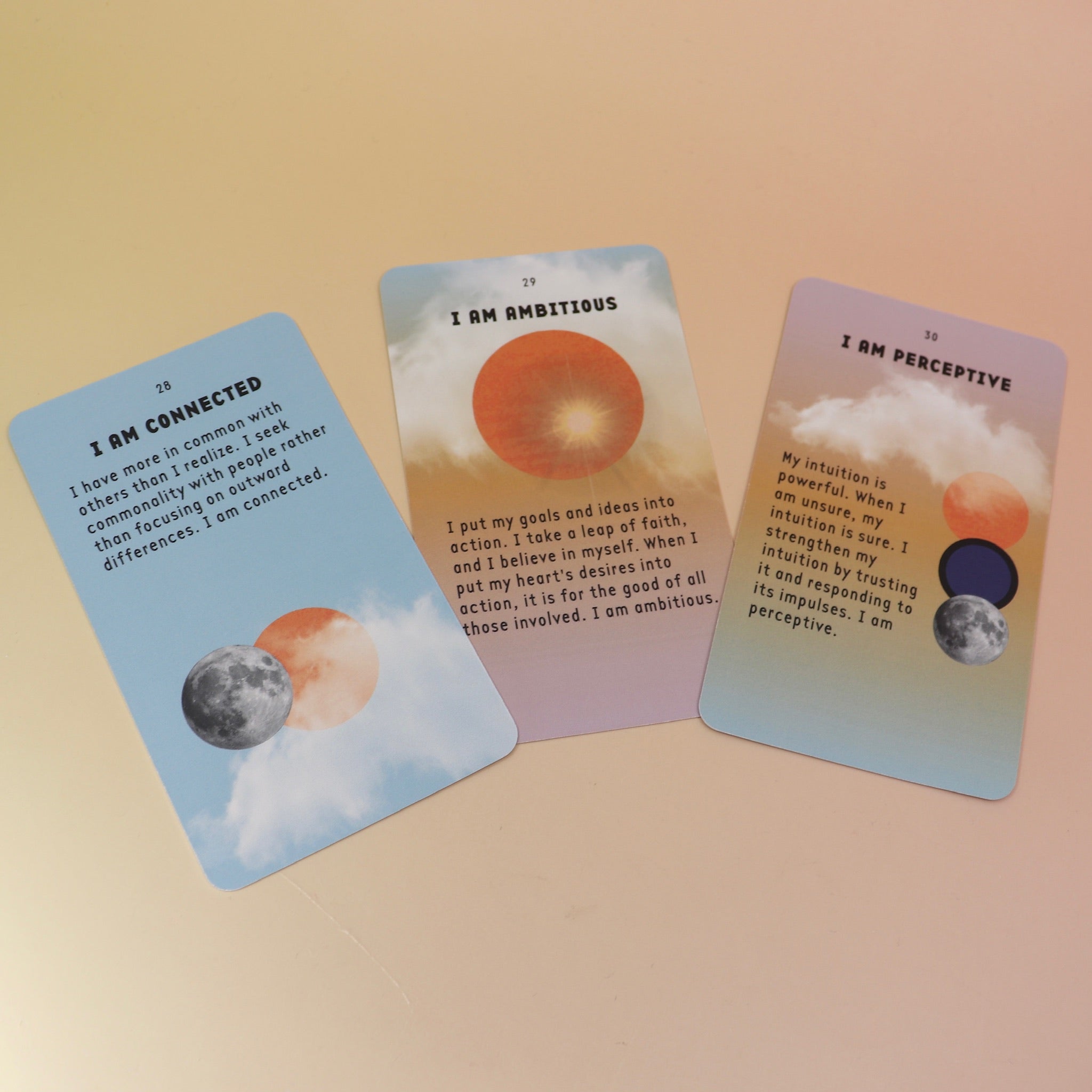 The contents of the Affirmation Card Deck  on a pink and yellow background.