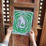 Someone holding the Stoner Cats Coloring Book in front of a wooden background, showing off the back.
