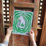 Someone holding the Stoner Cats Coloring Book in front of a wooden background, showing off the back.