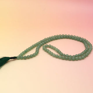 Jadeite 108 Mala Necklace on orange and pink background
