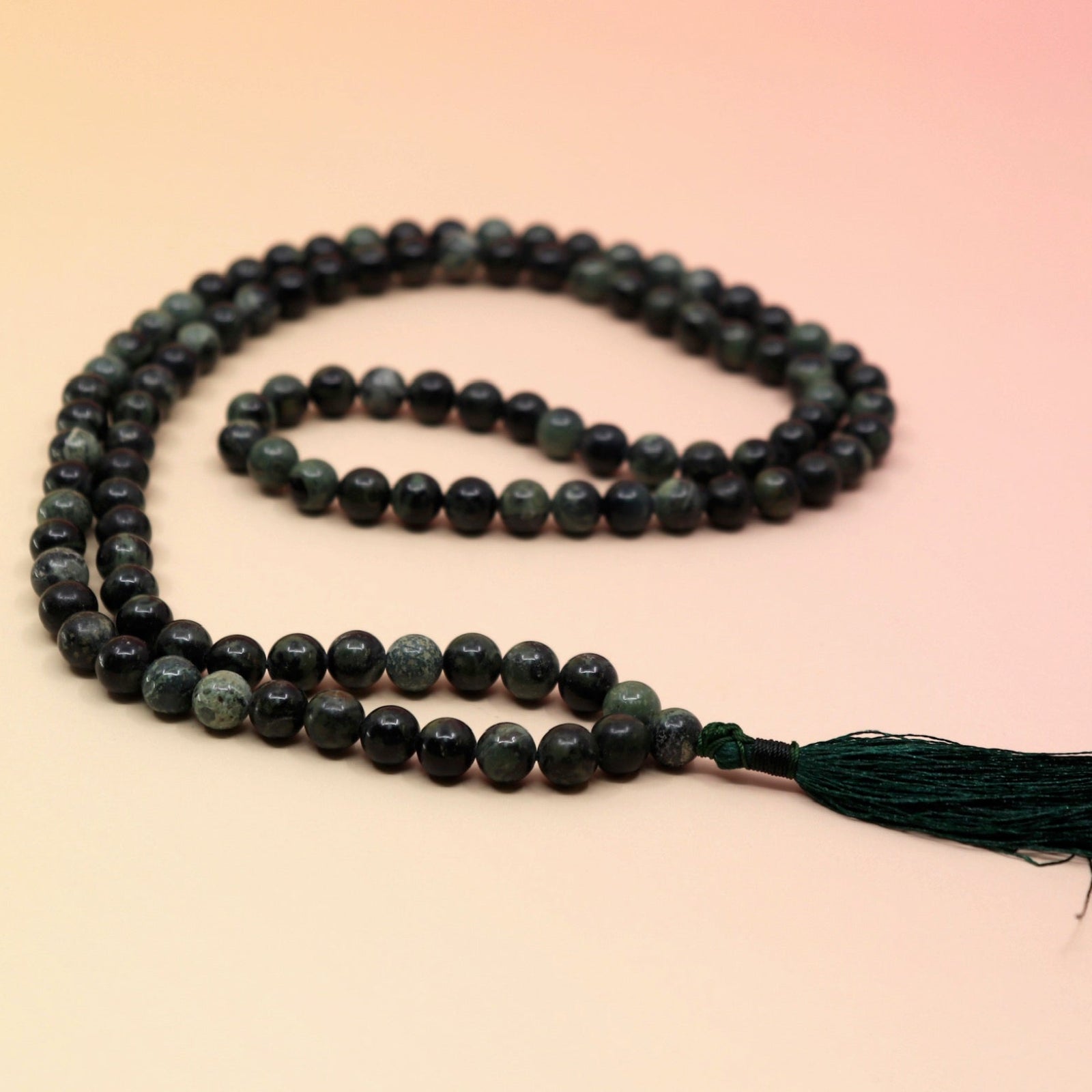Kambaba Jasper 108 Mala Necklace on pink and orange background