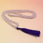 Lavender Quartz 108 Mala Necklace on pink and orange background