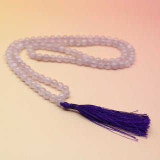 Lavender Quartz 108 Mala Necklace on pink and orange background