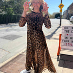 leopard mesh dress on model standing in front of orange and pink building with hands in claw formations growling