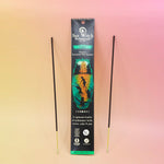 pack of incense with 2 sticks on either side on an orange and pink background