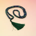 Malachite and Azurite Mala Necklace on orange and pink background