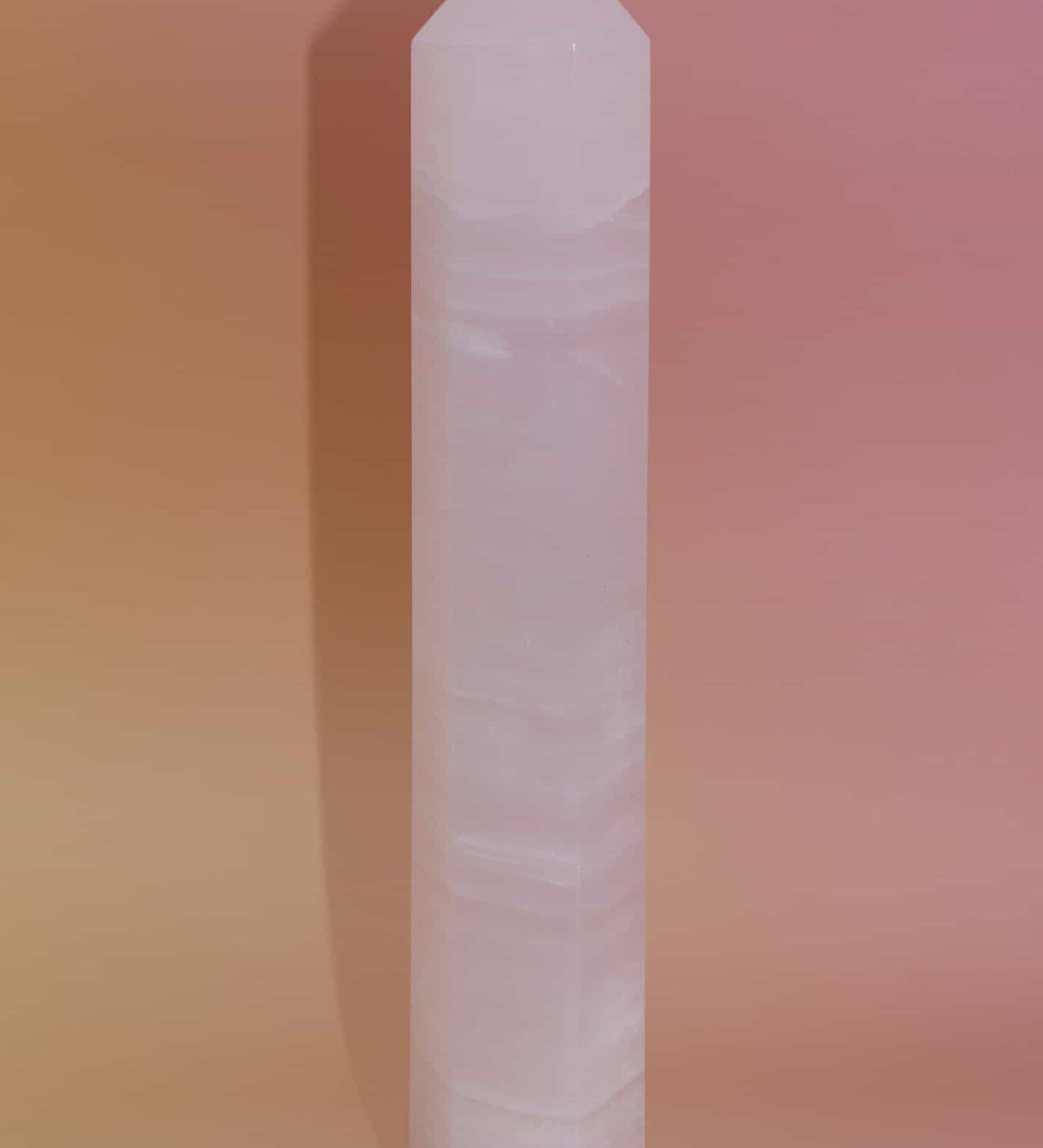 Crystal obelisk on a gradient pink and orange background