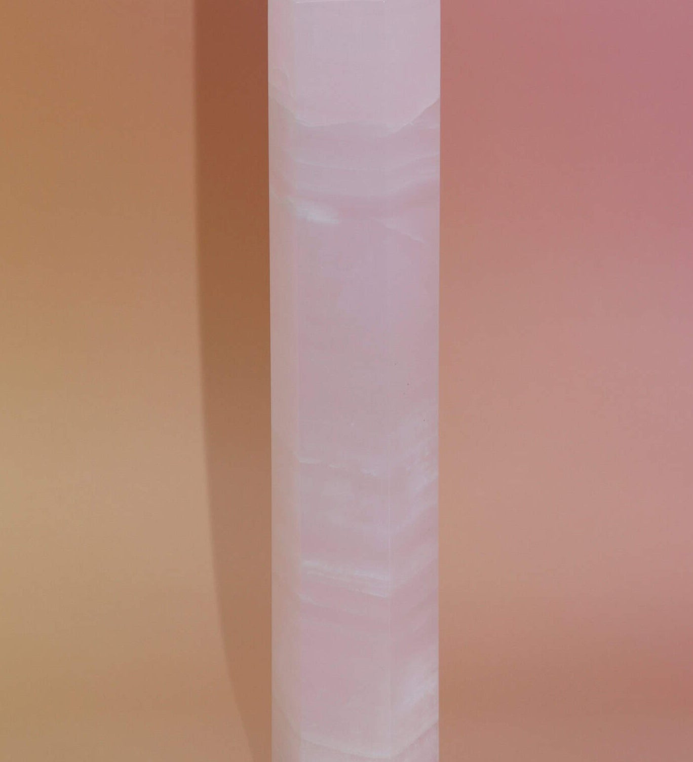 Crystal tower on a gradient pink background