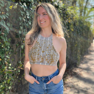 Cream moth print halter top styled with denim - ethical handmade fashion with model looking to the right