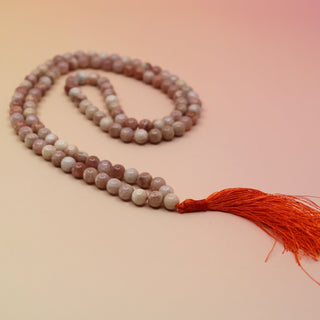Moonstone 108 Mala Necklace on pink and orange background