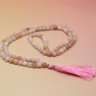 Morganite 108 Mala Necklace on pink and orange background