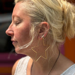 Gold-plated wire star earrings for statement look