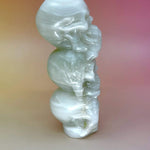 Side angle showing detailed carving of stacked skulls