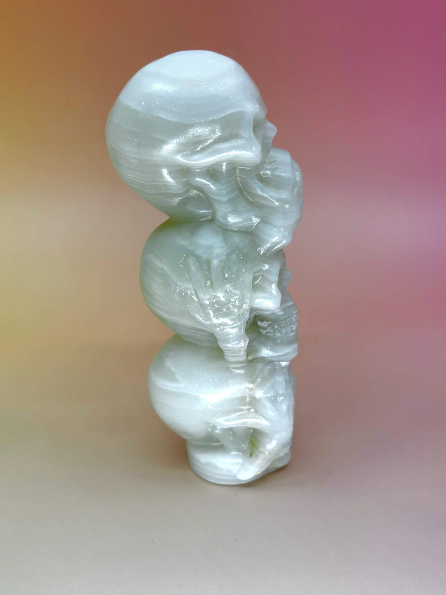 Side angle showing detailed carving of stacked skulls