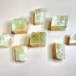 Selection of optical calcite cubes laid out on a light surface
