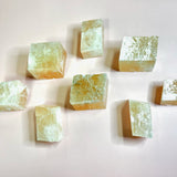 Selection of optical calcite cubes laid out on a light surface