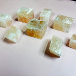 group of Iceland spar calcite cubes reflecting light naturally