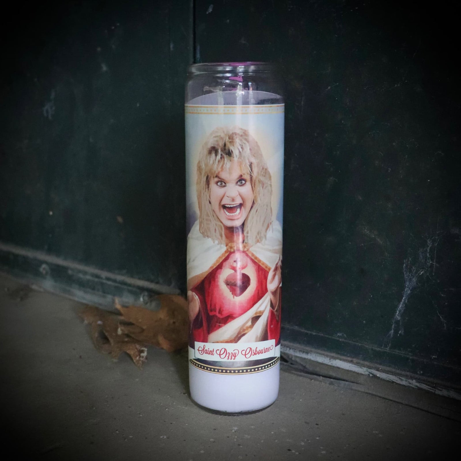Ozzy Osbourne Candle with a printed image of a person on a dark surface