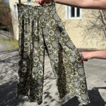 Someone holding the sage Celestial Faux Wrap Pants.