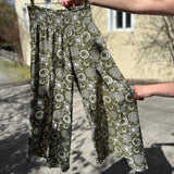 Someone holding the sage Celestial Faux Wrap Pants.