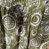 An up close image of the sage Celestial Faux Wrap Pants.