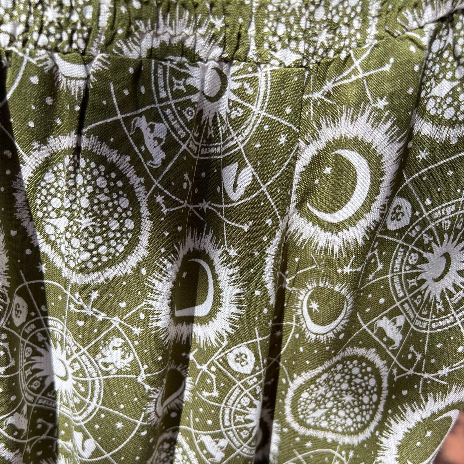 An up close image of the sage Celestial Faux Wrap Pants.
