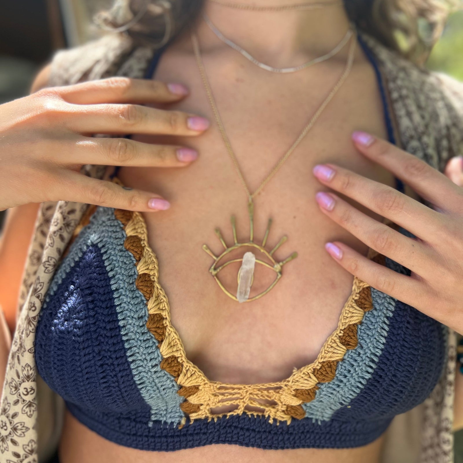 A woman wearing the navy Festive Crochet Top: One Size with a long patterned vest. 