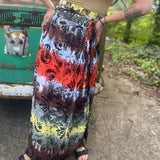 Someone wearing the Mushroom Tie-Dye Maxi Skirt in front of an old teal Volkswagen bus.