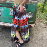 Someone wearing the Mushroom Tie-Dye Maxi Skirt in front of an old teal Volkswagen bus.
