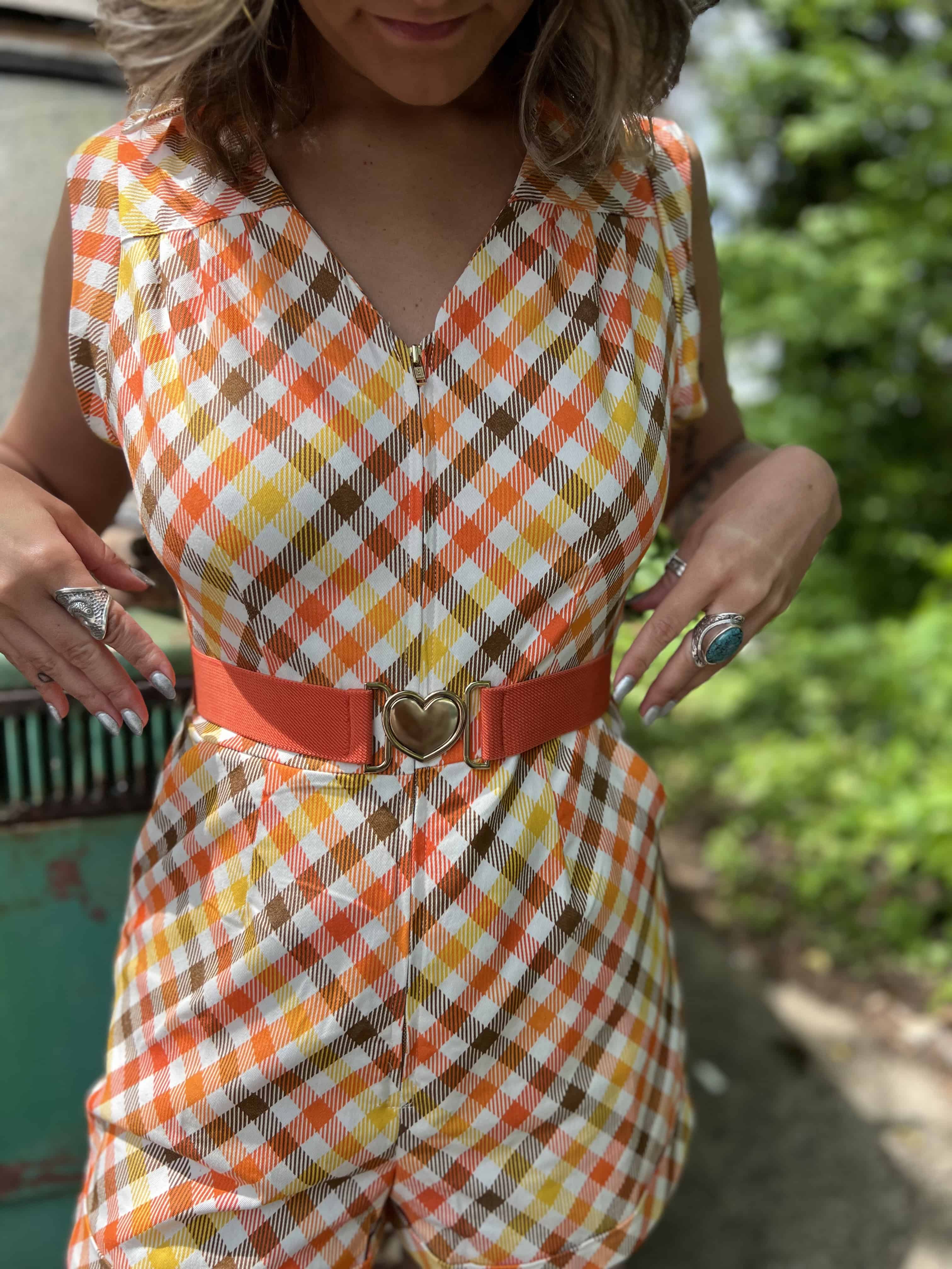 girl in 1970s Gingham Belted Romper in front of green VW vintage bus