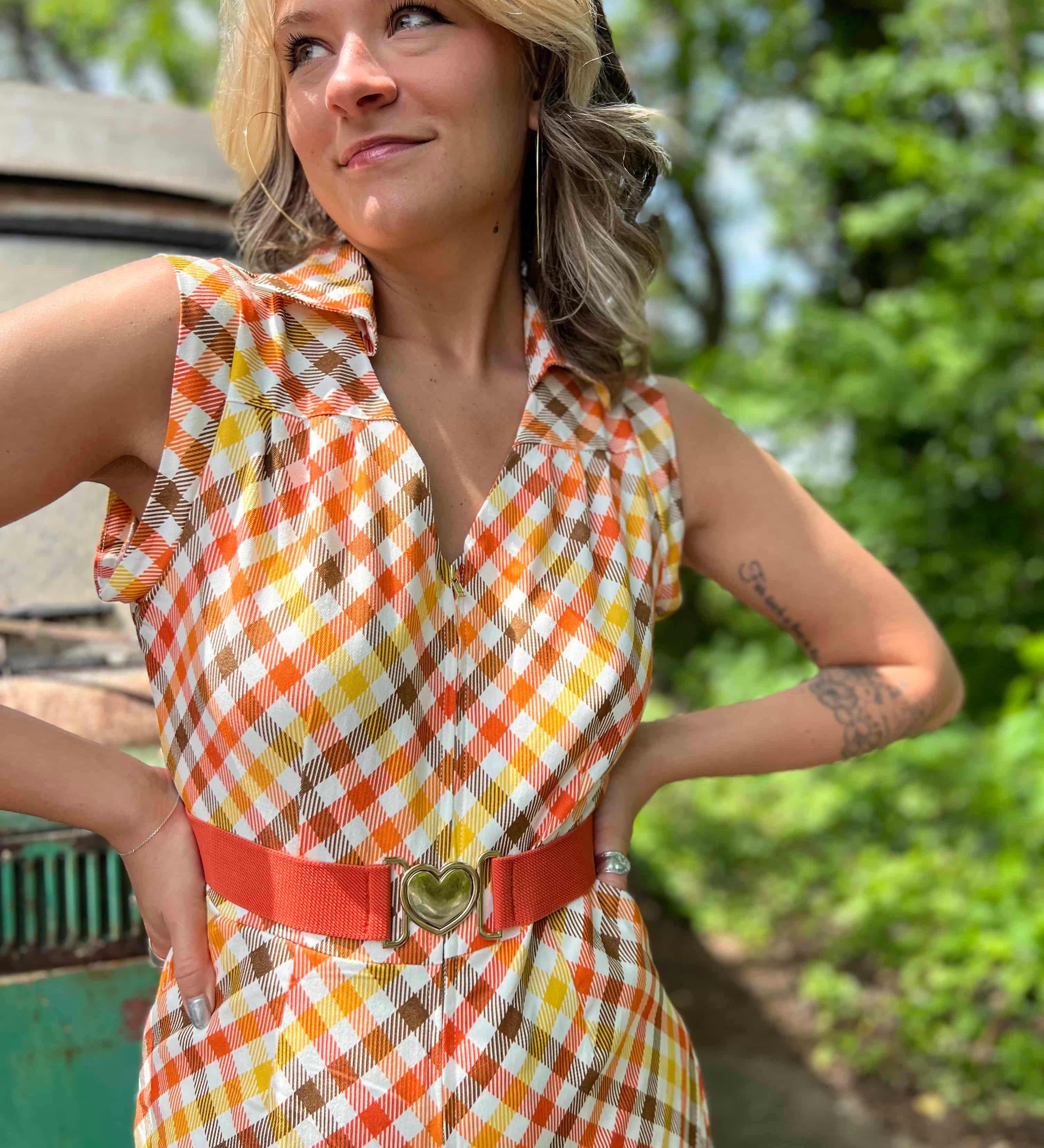 girl in 1970s Gingham Belted Romper in front of green VW vintage bus