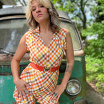 girl in 1970s Gingham Belted Romper in front of green VW vintage bus