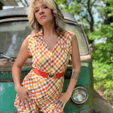 girl in 1970s Gingham Belted Romper in front of green VW vintage bus