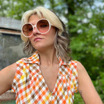 girl in 1970s Gingham Belted Romper in front of green VW vintage bus