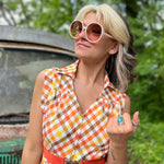 girl in 1970s Gingham Belted Romper in front of green VW vintage bus
