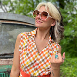girl in 1970s Gingham Belted Romper in front of green VW vintage bus