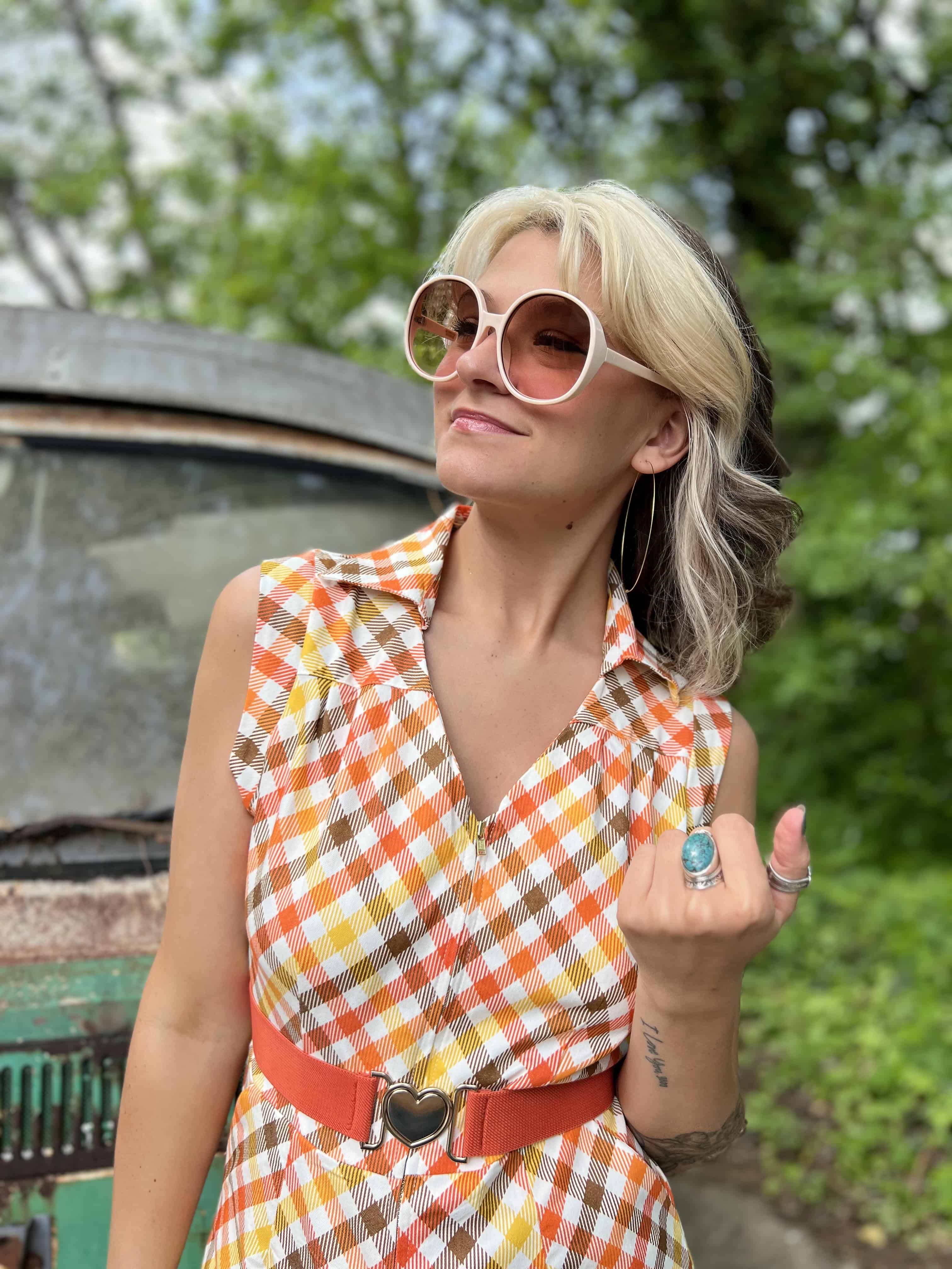 girl in 1970s Gingham Belted Romper in front of green VW vintage bus