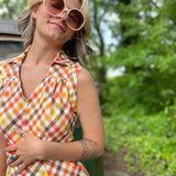 girl in 1970s Gingham Belted Romper in front of green VW vintage bus