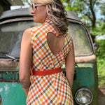 girl in 1970s Gingham Belted Romper in front of green VW vintage bus