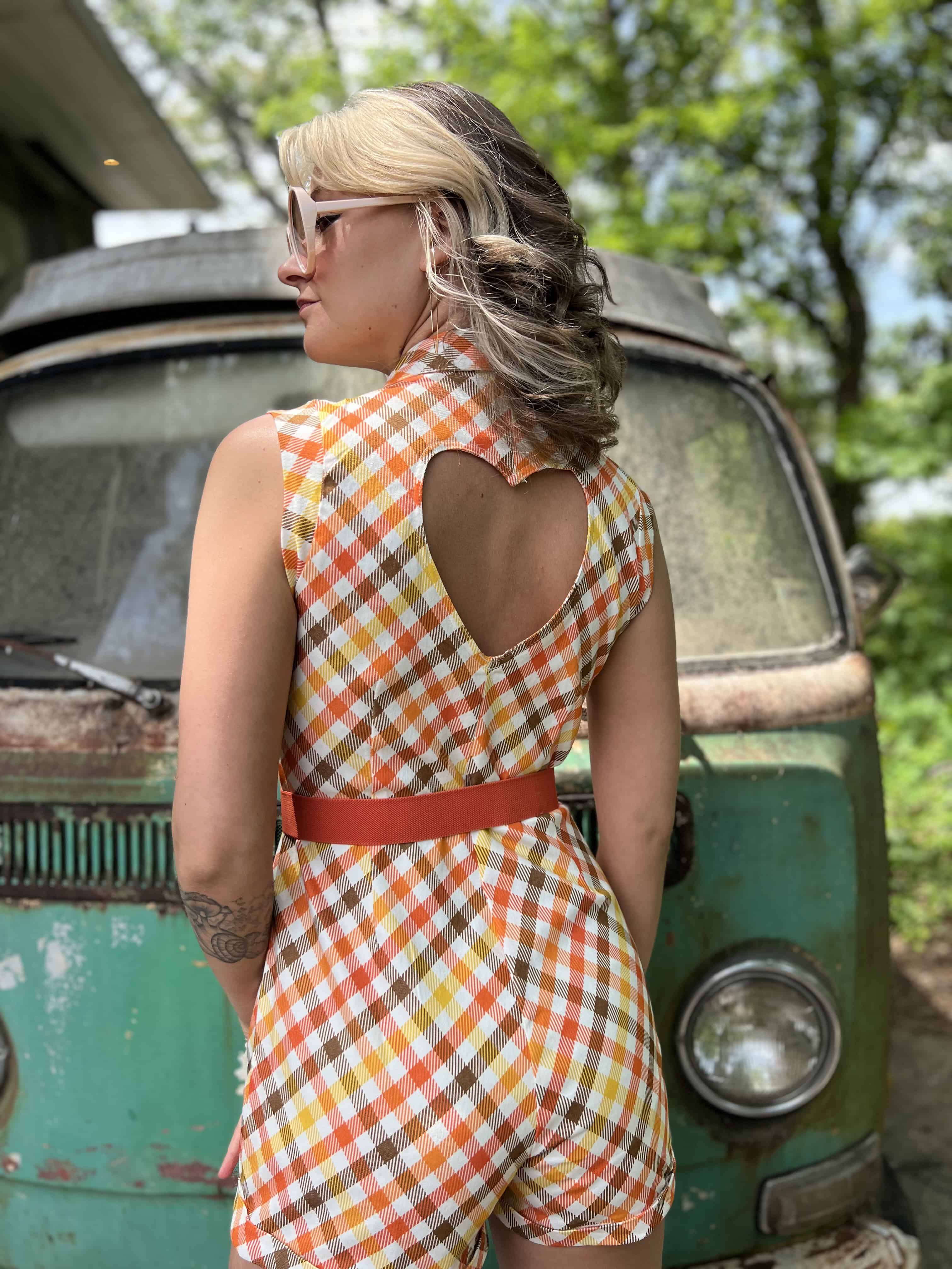 girl in 1970s Gingham Belted Romper in front of green VW vintage bus
