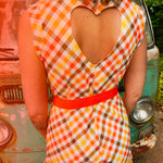 girl in 1970s Gingham Belted Romper in front of green VW vintage bus